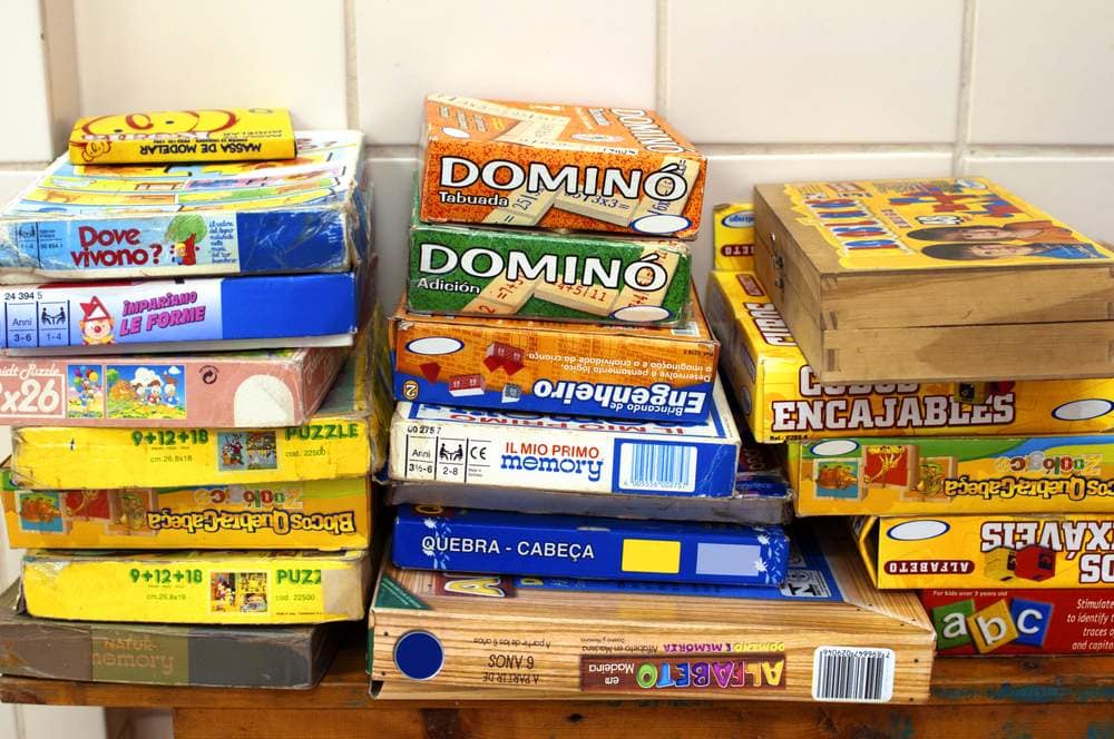 boxes of board games stacked on a table