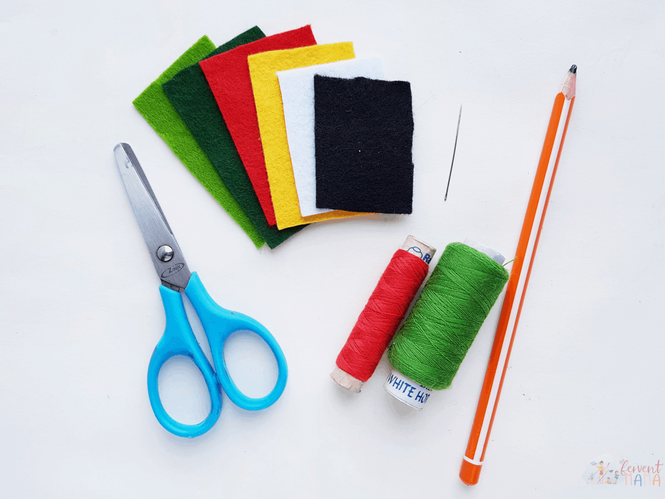 Various colors of felt and thread with a small pair of scissors and a pencil.