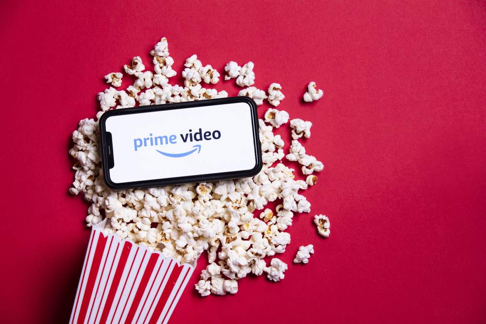Amazon Prime video logo on a smartphone with popcorn