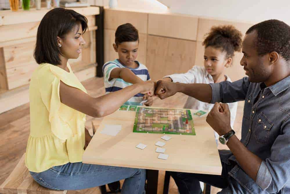 Mom and dad playing a board game with kids