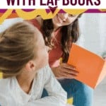 girl looking at mom working on lapbooks together with text overlay 