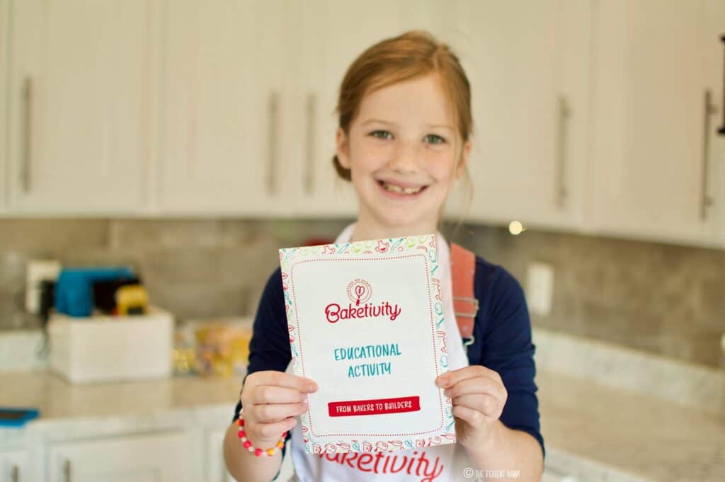 Child showing off the Baketivity Educational Activity Book