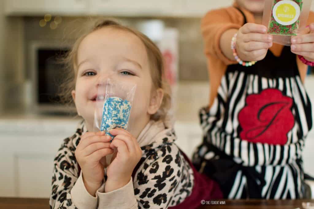 Toddlers holding Baketivity pre-packaged sprinkles.